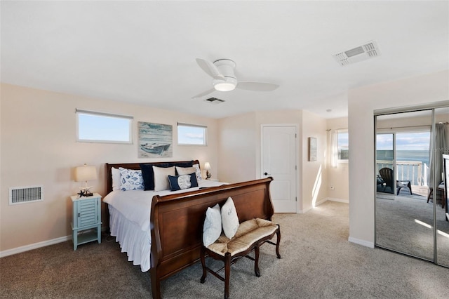 carpeted bedroom featuring visible vents, baseboards, and ceiling fan