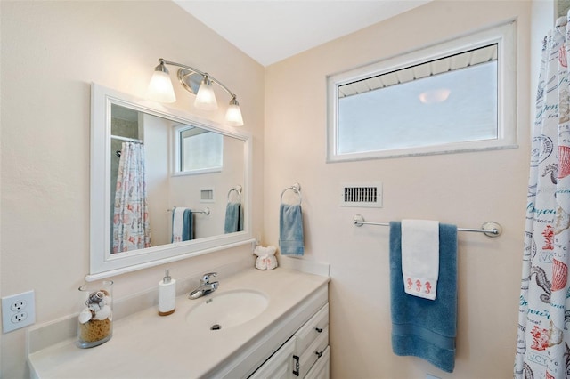 bathroom featuring visible vents, a shower with curtain, and vanity