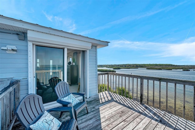wooden terrace featuring a water view