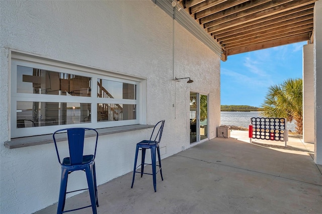 view of patio with a water view