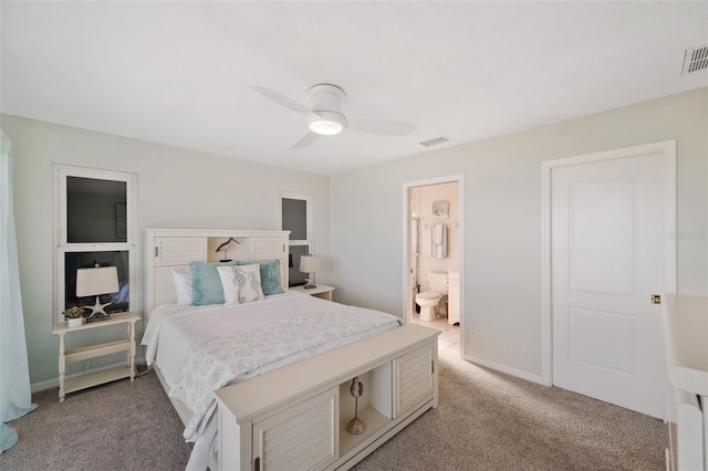 bedroom featuring ensuite bathroom, ceiling fan, light carpet, and visible vents