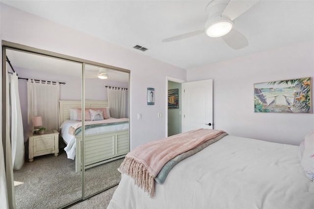 bedroom with carpet flooring, a ceiling fan, visible vents, and a closet