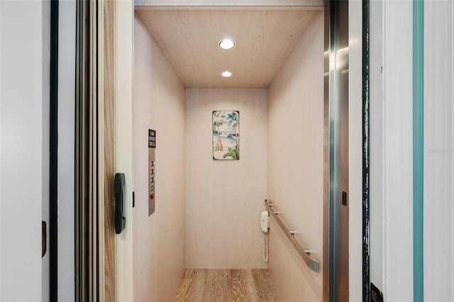 interior space with recessed lighting, elevator, and an upstairs landing