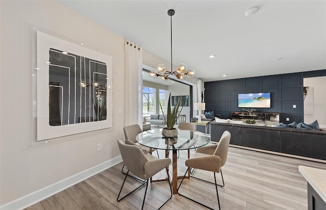 dining room featuring recessed lighting, baseboards, a notable chandelier, and light wood finished floors