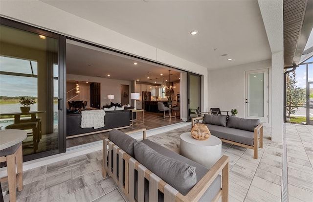 living area featuring recessed lighting and a notable chandelier