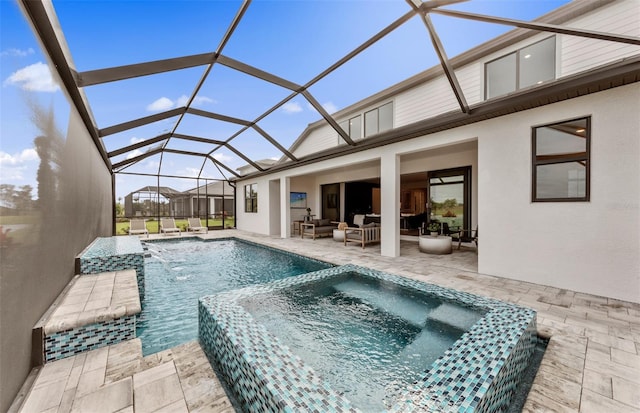 view of pool with a lanai, a patio area, a pool with connected hot tub, and an outdoor hangout area