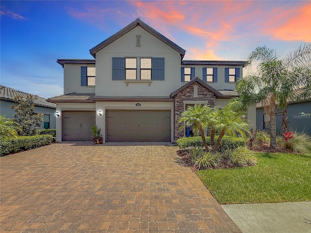 18203 Pine Hammock Blvd, Lutz, FL 33548 - view of front of home with stucco siding, an attached garage, decorative driveway, and stone siding