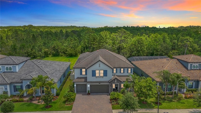 18203 Pine Hammock Blvd, Lutz, FL 33548 - view of front facade with stucco siding, a tiled roof, and a forest view