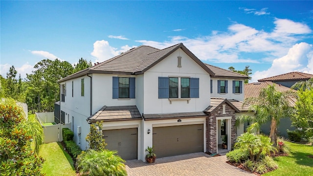 18203 Pine Hammock Blvd, Lutz, FL 33548 - view of front of house featuring a garage, stucco siding, decorative driveway, stone siding, and a tile roof