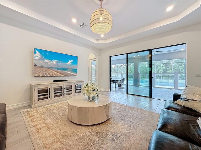 18203 Pine Hammock Blvd, Lutz, FL 33548 - living area with recessed lighting, a tray ceiling, baseboards, and arched walkways