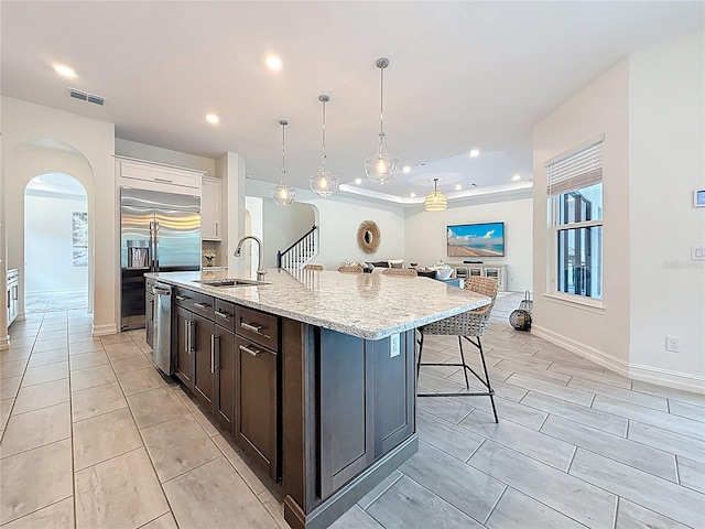 18203 Pine Hammock Blvd, Lutz, FL 33548 - kitchen with a sink, arched walkways, a kitchen breakfast bar, a kitchen island with sink, and stainless steel appliances