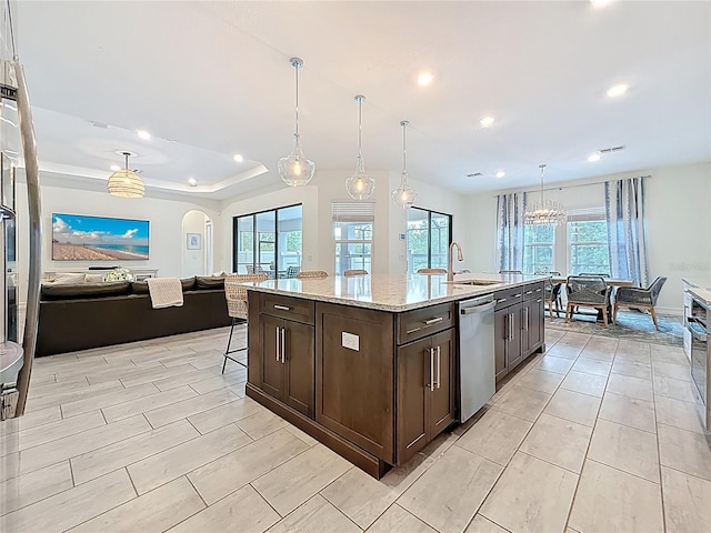 18203 Pine Hammock Blvd, Lutz, FL 33548 - kitchen with stainless steel dishwasher, a sink, dark brown cabinetry, open floor plan, and recessed lighting