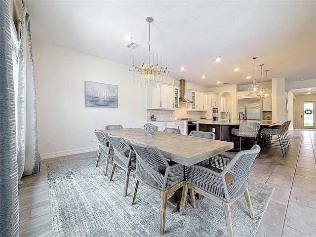18203 Pine Hammock Blvd, Lutz, FL 33548 - dining space featuring arched walkways, a chandelier, recessed lighting, and baseboards