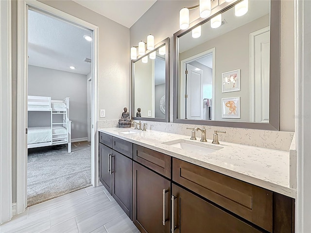 18203 Pine Hammock Blvd, Lutz, FL 33548 - full bath featuring double vanity, connected bathroom, and baseboards