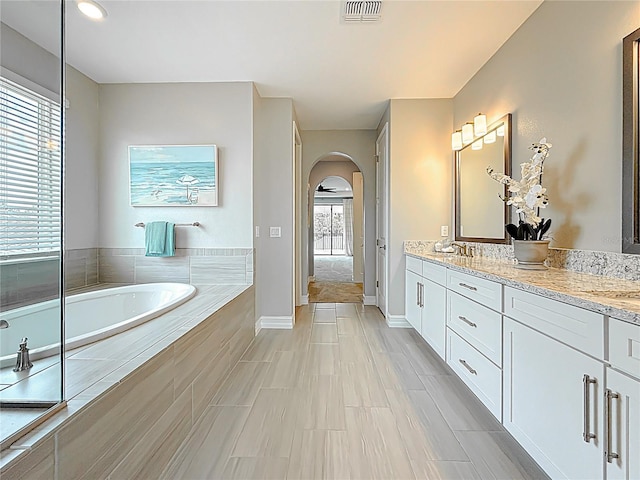 18203 Pine Hammock Blvd, Lutz, FL 33548 - full bathroom featuring a bath, double vanity, and baseboards