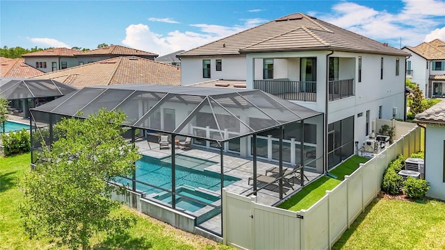 18203 Pine Hammock Blvd, Lutz, FL 33548 - rear view of property featuring a patio, an outdoor hot tub, a tiled roof, stucco siding, and cooling unit