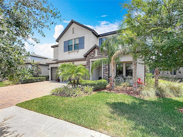 18203 Pine Hammock Blvd, Lutz, FL 33548 - view of front of house featuring stone siding, stucco siding, an attached garage, decorative driveway, and a front yard
