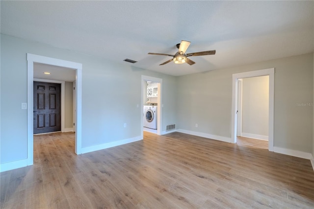 spare room with visible vents, a ceiling fan, baseboards, and light wood-type flooring