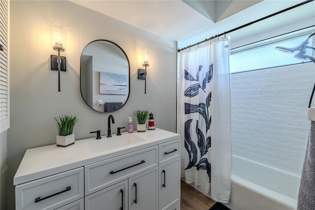 full bathroom featuring vanity, wood finished floors, and shower / bath combo with shower curtain