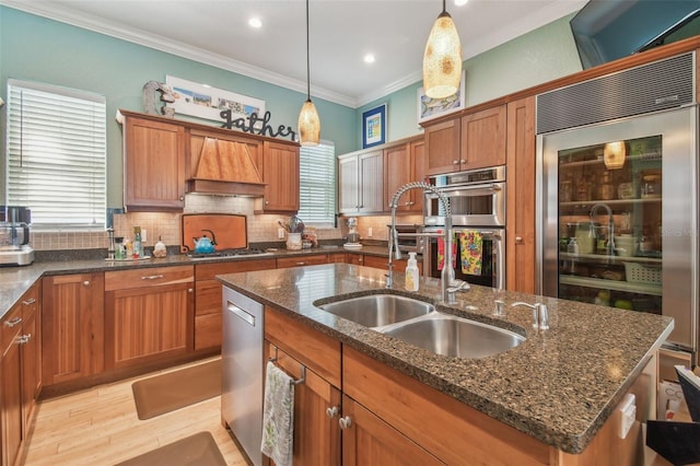 1326 Apollo Beach Blvd S, Apollo Beach, FL 33572 - kitchen featuring crown molding, an island with sink, brown cabinets, a sink, and stainless steel appliances