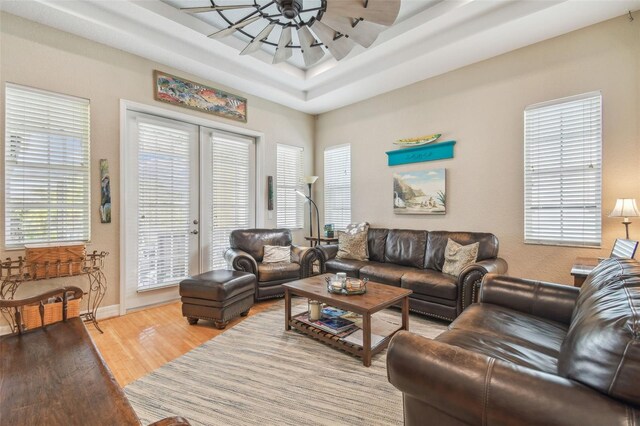 1326 Apollo Beach Blvd S, Apollo Beach, FL 33572 - living room featuring baseboards, ceiling fan, wood finished floors, and a tray ceiling