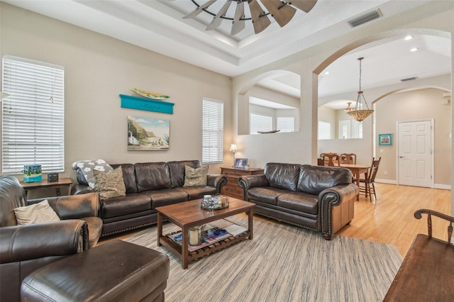 1326 Apollo Beach Blvd S, Apollo Beach, FL 33572 - living area with visible vents, arched walkways, light wood-type flooring, a tray ceiling, and recessed lighting