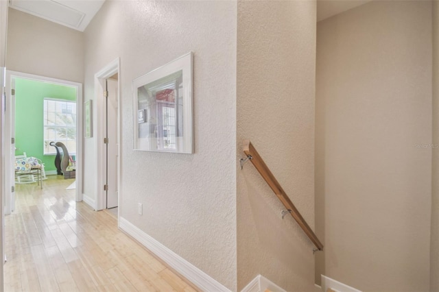 1326 Apollo Beach Blvd S, Apollo Beach, FL 33572 - hall with a textured wall, an upstairs landing, baseboards, and light wood finished floors