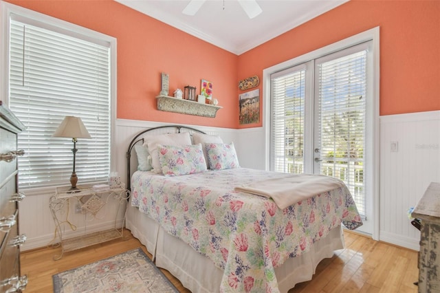 1326 Apollo Beach Blvd S, Apollo Beach, FL 33572 - bedroom featuring crown molding, access to exterior, a wainscoted wall, a ceiling fan, and wood finished floors