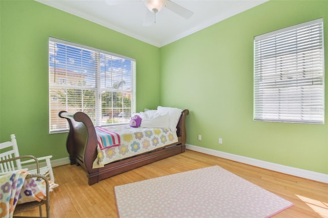 1326 Apollo Beach Blvd S, Apollo Beach, FL 33572 - bedroom featuring baseboards, multiple windows, wood finished floors, and ornamental molding