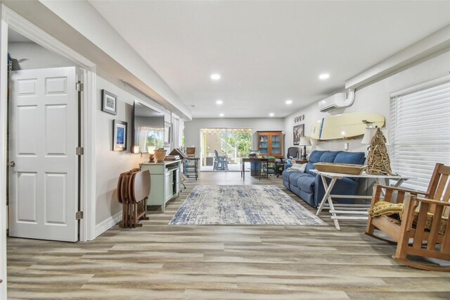 1326 Apollo Beach Blvd S, Apollo Beach, FL 33572 - sitting room with recessed lighting, baseboards, a wall mounted AC, and wood finished floors