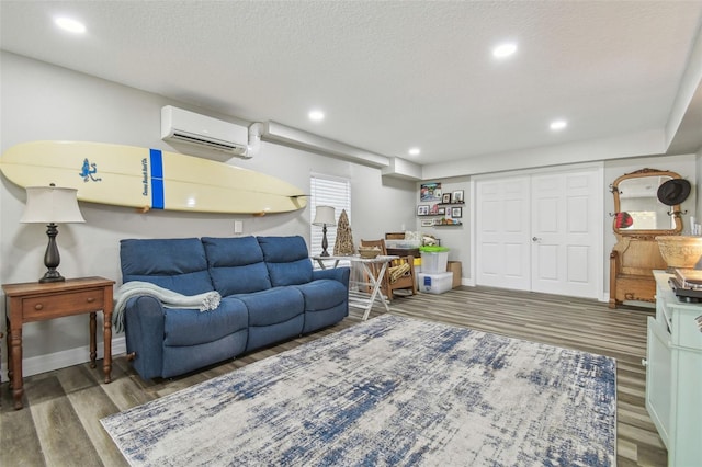 1326 Apollo Beach Blvd S, Apollo Beach, FL 33572 - living room with a textured ceiling, an AC wall unit, recessed lighting, and wood finished floors