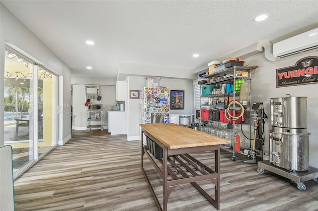 1326 Apollo Beach Blvd S, Apollo Beach, FL 33572 - dining area with baseboards, a wall unit AC, recessed lighting, and wood finished floors