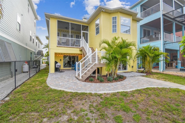 1326 Apollo Beach Blvd S, Apollo Beach, FL 33572 - rear view of property featuring a sunroom, fence, stairway, and a patio
