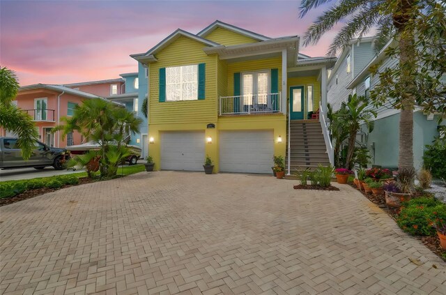 1326 Apollo Beach Blvd S, Apollo Beach, FL 33572 - coastal home with an attached garage, decorative driveway, covered porch, and stairway