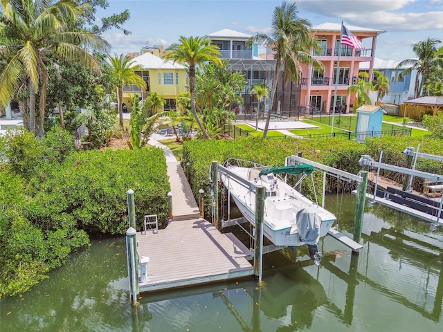 1326 Apollo Beach Blvd S, Apollo Beach, FL 33572 - view of dock featuring fence, boat lift, a water view, and a lawn