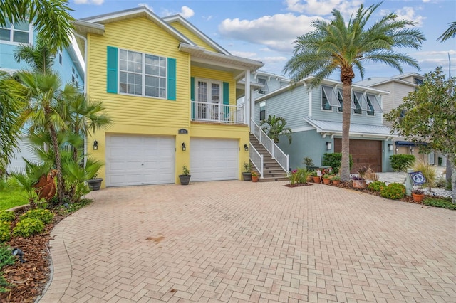 1326 Apollo Beach Blvd S, Apollo Beach, FL 33572 - beach home featuring an attached garage, decorative driveway, stucco siding, and stairway