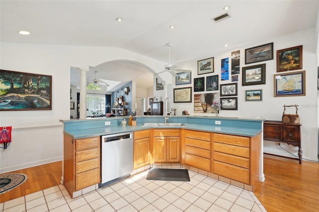 kitchen with ceiling fan, a sink, dishwasher, lofted ceiling, and visible vents