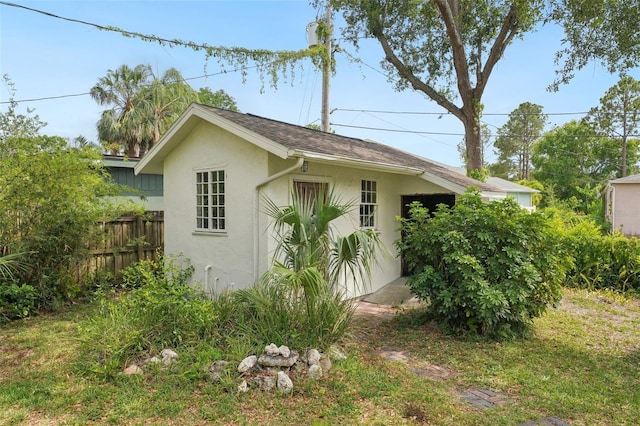 view of outdoor structure featuring fence and an outbuilding