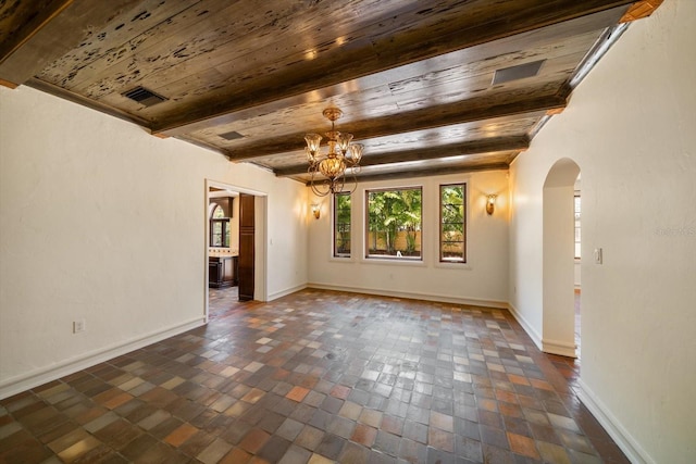 unfurnished room featuring an inviting chandelier, beam ceiling, baseboards, wood ceiling, and arched walkways