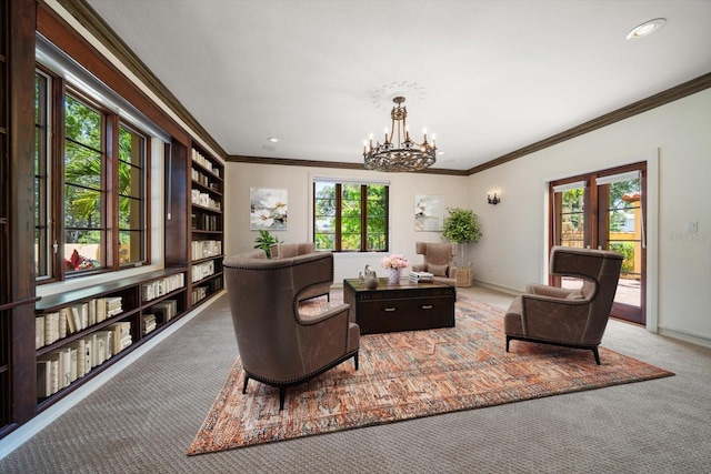 sitting room featuring crown molding, baseboards, an inviting chandelier, and carpet flooring