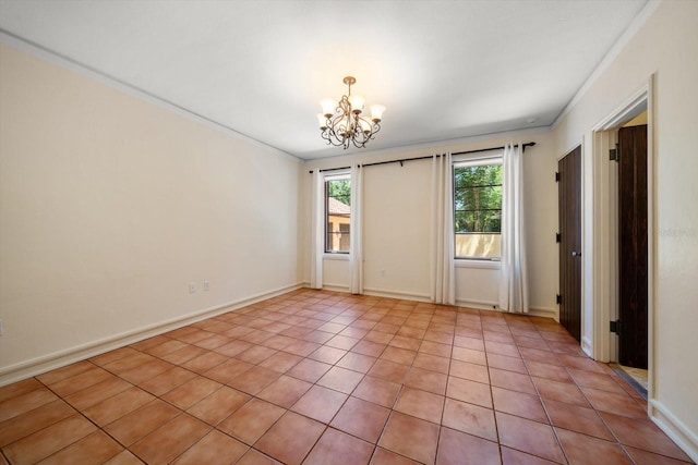 spare room featuring crown molding, light tile patterned flooring, and a chandelier