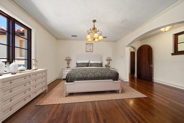 bedroom featuring an inviting chandelier, arched walkways, baseboards, and dark wood-style flooring