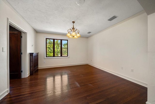 empty room featuring a textured ceiling, a chandelier, wood finished floors, visible vents, and ornamental molding