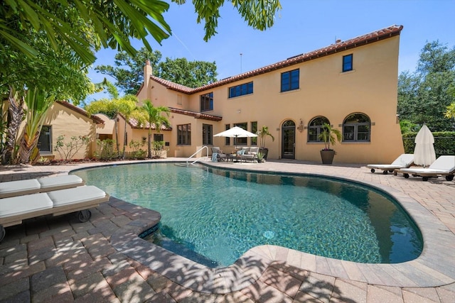 outdoor pool with a patio area