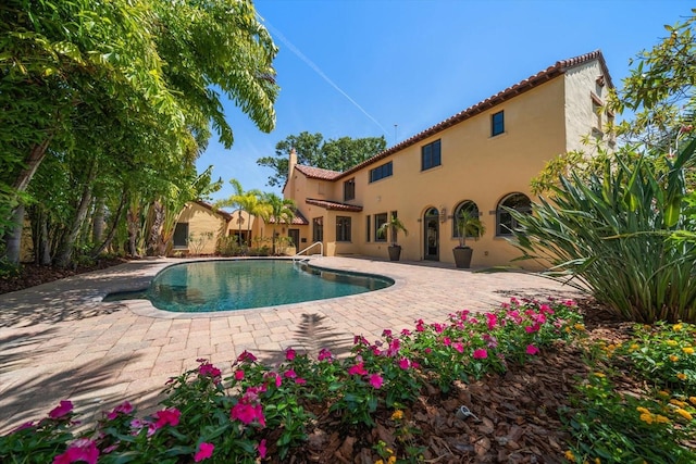 outdoor pool with a patio area