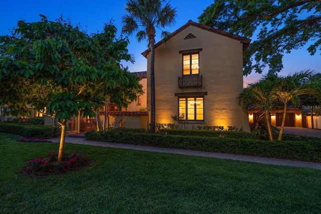 mediterranean / spanish-style house with a lawn
