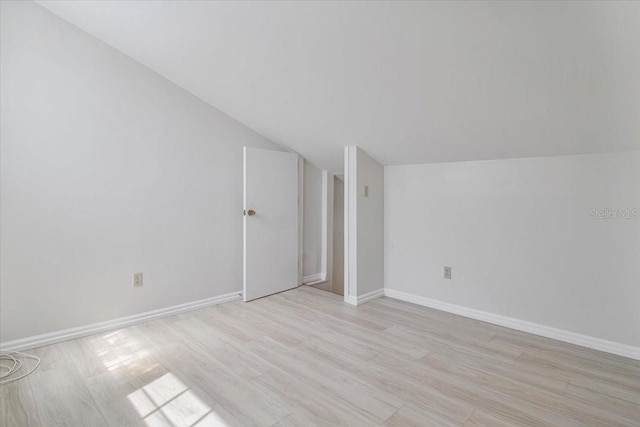 2728 58th St S, Gulfport, FL 33707 - bonus room with vaulted ceiling, light wood-type flooring, and baseboards