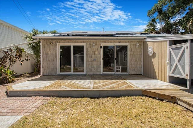 2728 58th St S, Gulfport, FL 33707 - back of property with solar panels and a deck