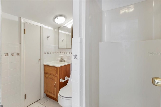 2728 58th St S, Gulfport, FL 33707 - bathroom with tile walls, tile patterned flooring, vanity, and toilet