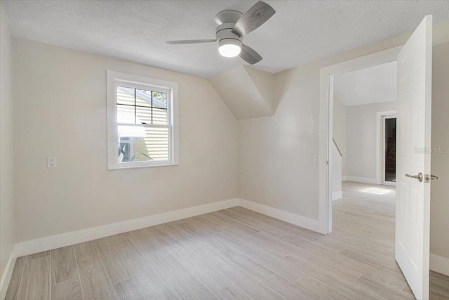 2728 58th St S, Gulfport, FL 33707 - additional living space featuring light wood-style floors, baseboards, a textured ceiling, and ceiling fan